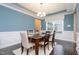 Inviting dining area featuring a modern chandelier, a large window, and a comfortable seating arrangement on a soft rug at 522 Finnbar Dr, Cary, NC 27519