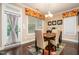 Cozy dining room area with a floral curtain, a modern chandelier, and a door that leads out to a deck at 522 Finnbar Dr, Cary, NC 27519