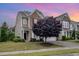 Charming two-story home with a combination of brick and siding, complemented by a beautifully landscaped front yard and a mature tree at 522 Finnbar Dr, Cary, NC 27519