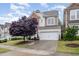 Inviting exterior showcasing a well-maintained lawn and a spacious driveway leading to an attached garage at 522 Finnbar Dr, Cary, NC 27519