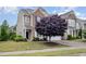Charming two-story home with a combination of brick and siding, complemented by a beautifully landscaped front yard and a mature tree at 522 Finnbar Dr, Cary, NC 27519