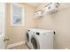 Well-lit laundry room with modern washer and dryer, and storage shelving at 522 Finnbar Dr, Cary, NC 27519