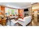 Cozy living room showcases a stone fireplace, hardwood floors, and comfortable seating, perfect for relaxation and entertaining at 522 Finnbar Dr, Cary, NC 27519