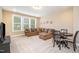 Inviting living room with plush seating, a dining table and lots of natural light at 522 Finnbar Dr, Cary, NC 27519