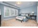 Serene main bedroom with large windows, a tray ceiling, and a sitting area at 522 Finnbar Dr, Cary, NC 27519