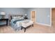 Comfortable main bedroom with decorative pillows, upholstered headboard, and a connecting ensuite at 522 Finnbar Dr, Cary, NC 27519