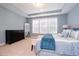 Comfortable main bedroom with natural light, a sitting bench, and a dresser at 522 Finnbar Dr, Cary, NC 27519