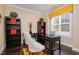 Cozy office with a black desk, shelving units, and natural light from the window at 522 Finnbar Dr, Cary, NC 27519