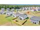 An aerial view showcases the spacious backyard, play set, and the home's position in the community at 604 Salmonberry Dr, Holly Springs, NC 27540