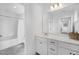 Clean bathroom featuring a vanity with modern fixtures, a large mirror, and a shower with clear doors at 604 Salmonberry Dr, Holly Springs, NC 27540