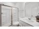Modern bathroom with a glass-enclosed shower, a white vanity, and sleek fixtures for a clean aesthetic at 604 Salmonberry Dr, Holly Springs, NC 27540