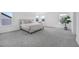Expansive bedroom featuring plush carpet, bright windows, and comfortable furnishings creating a peaceful retreat at 604 Salmonberry Dr, Holly Springs, NC 27540
