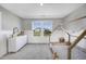 Stylish bedroom with lovely wallpaper, a canopy bed, and a window with views of the surrounding landscape at 604 Salmonberry Dr, Holly Springs, NC 27540