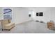 Bright bonus room featuring neutral colors, a comfortable chair, plush carpet, and a window with natural light at 604 Salmonberry Dr, Holly Springs, NC 27540