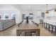 Open-concept dining area flows into the kitchen, featuring a large table perfect for gatherings and everyday meals at 604 Salmonberry Dr, Holly Springs, NC 27540
