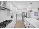 Well-equipped kitchen with stainless steel appliances, stylish backsplash, and ample cabinet space for storage at 604 Salmonberry Dr, Holly Springs, NC 27540