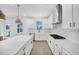 Bright kitchen with white cabinets, stainless steel appliances, and a center island, offering ample workspace at 604 Salmonberry Dr, Holly Springs, NC 27540