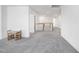 Spacious loft area featuring plush carpeting, ample lighting, and charming table with stair access at 604 Salmonberry Dr, Holly Springs, NC 27540