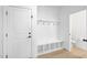 Bright mudroom features built-in bench with storage, convenient hooks, and easy access to the downstairs bathroom at 604 Salmonberry Dr, Holly Springs, NC 27540