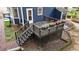 View of the back deck with stairs and potted flower boxes at the backyard of a blue house at 6717 Ebon Ct, Raleigh, NC 27615