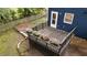 View of back deck with potted flower boxes at the backyard of a blue house with a picket fence at 6717 Ebon Ct, Raleigh, NC 27615