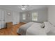 Inviting bedroom featuring wood floors, a ceiling fan, and a neutral color palette at 6717 Ebon Ct, Raleigh, NC 27615