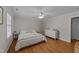 Well-lit bedroom with hardwood floors, a ceiling fan, and ample natural light at 6717 Ebon Ct, Raleigh, NC 27615
