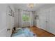 Cozy bedroom with hardwood floors, a bright window, and a double door closet at 6717 Ebon Ct, Raleigh, NC 27615