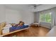 Bright bedroom with hardwood floors, large window and a ceiling fan at 6717 Ebon Ct, Raleigh, NC 27615