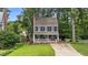 Charming two-story home featuring blue siding, white trim, black shutters and inviting front porch at 6717 Ebon Ct, Raleigh, NC 27615