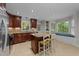 Spacious kitchen with granite countertops, center island, stainless fridge, and eat in breakfast nook at 6717 Ebon Ct, Raleigh, NC 27615