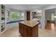 Bright eat-in kitchen featuring center island, window seat, and adjacent laundry area at 6717 Ebon Ct, Raleigh, NC 27615