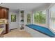 Eat-in kitchen features a built-in shelving unit and a large sunny window seat with backyard views at 6717 Ebon Ct, Raleigh, NC 27615