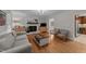 Cozy living room features fireplace, hardwood floors, neutral paint and an abundance of natural light at 6717 Ebon Ct, Raleigh, NC 27615