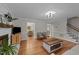 Bright living room with hardwood floors, fireplace, an abundance of natural light, and neutral paint at 6717 Ebon Ct, Raleigh, NC 27615
