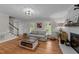 Spacious living room with hardwood floors, fireplace, lots of natural light and neutral paint at 6717 Ebon Ct, Raleigh, NC 27615
