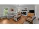 Cozy living room features fireplace, hardwood floors, neutral paint and an abundance of natural light at 6717 Ebon Ct, Raleigh, NC 27615