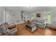 Spacious living room with hardwood floors, fireplace, lots of natural light and neutral paint at 6717 Ebon Ct, Raleigh, NC 27615