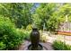 Lush backyard oasis features a large fountain surrounded by greenery, creating a serene atmosphere at 676 Whitehurst, Pittsboro, NC 27312