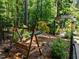 Secluded backyard with swing, arbor, and mature trees offers a peaceful retreat at 676 Whitehurst, Pittsboro, NC 27312
