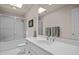 Bright bathroom features white vanity, large mirror, and shower with glass door at 676 Whitehurst, Pittsboro, NC 27312