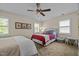 Cozy bedroom featuring twin beds, neutral walls, and natural light from shuttered windows at 676 Whitehurst, Pittsboro, NC 27312