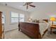 Serene bedroom features a large bed, ceiling fan and plantation shutters for natural light at 676 Whitehurst, Pittsboro, NC 27312