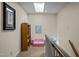 Hallway with a skylight, pink sofa, built-in bookcase and carpeted floors at 676 Whitehurst, Pittsboro, NC 27312