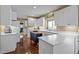 Bright kitchen featuring white cabinets, light countertops, an island and dark hardwood floors at 676 Whitehurst, Pittsboro, NC 27312