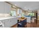 Bright kitchen with white cabinets, stainless steel sink, and an island with butcher block countertop at 676 Whitehurst, Pittsboro, NC 27312