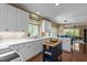 Bright kitchen with white cabinets, stainless steel sink, and an island with butcher block countertop at 676 Whitehurst, Pittsboro, NC 27312