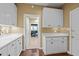 Kitchen featuring modern white cabinets and countertops with hardwood floors and a walk-through to the next room at 676 Whitehurst, Pittsboro, NC 27312