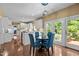 Bright eat-in kitchen features white cabinets, stainless appliances, hardwood floors and access to outdoor living space at 676 Whitehurst, Pittsboro, NC 27312