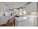 Bright kitchen featuring white cabinets, light countertops, an island and dark hardwood floors at 676 Whitehurst, Pittsboro, NC 27312
